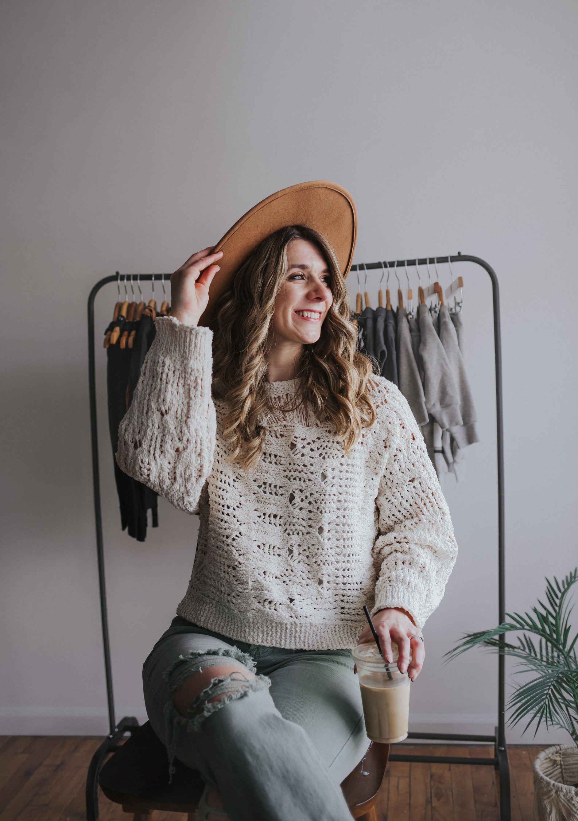 Founder of Raising Brave wearing stylish wide brim hat, crocheted top, and distressed jeans