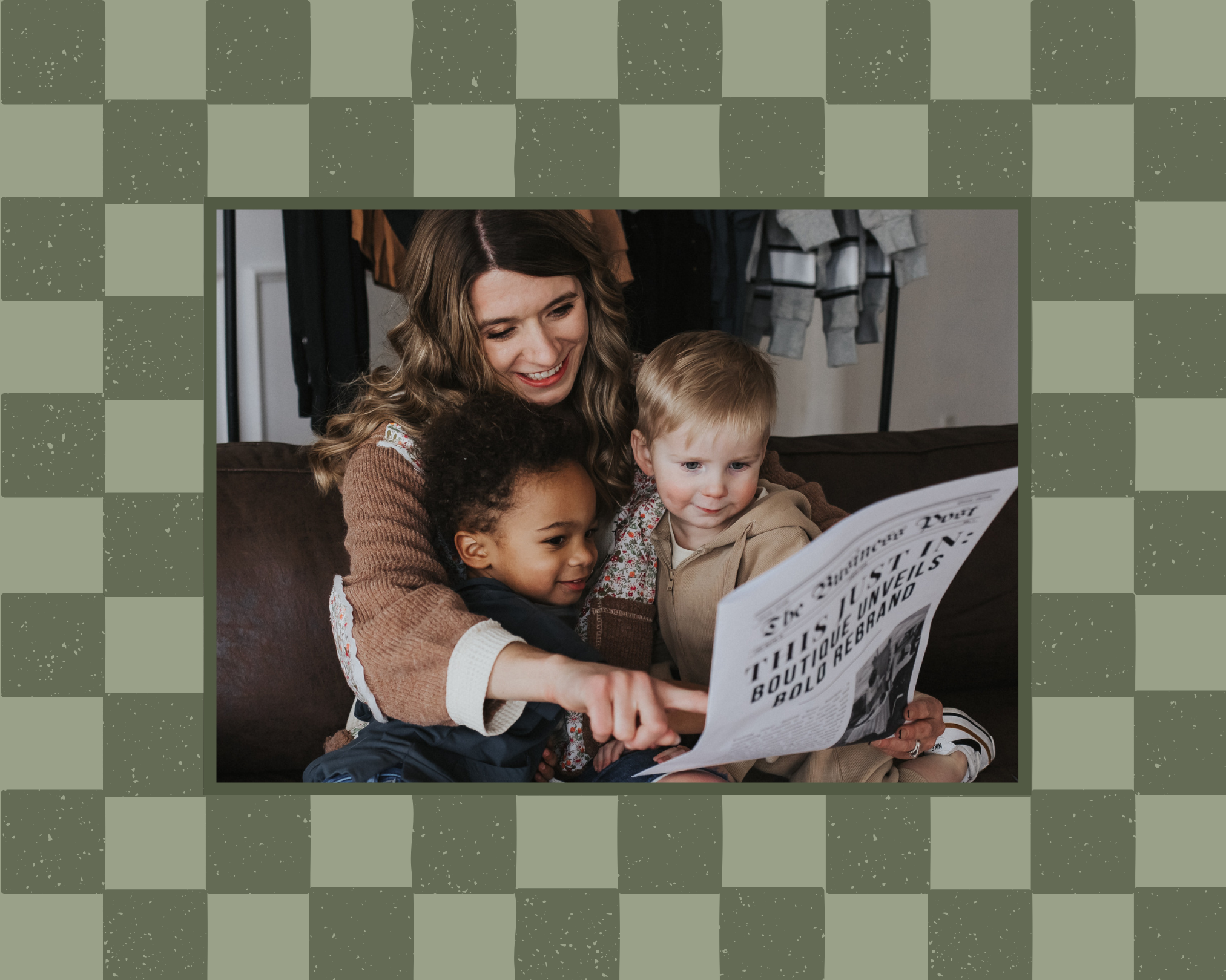 Mom sitting on a leather couch reading with her two boys