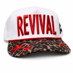 White cap with red 'REVIVAL' text and leopard print brim on a white background