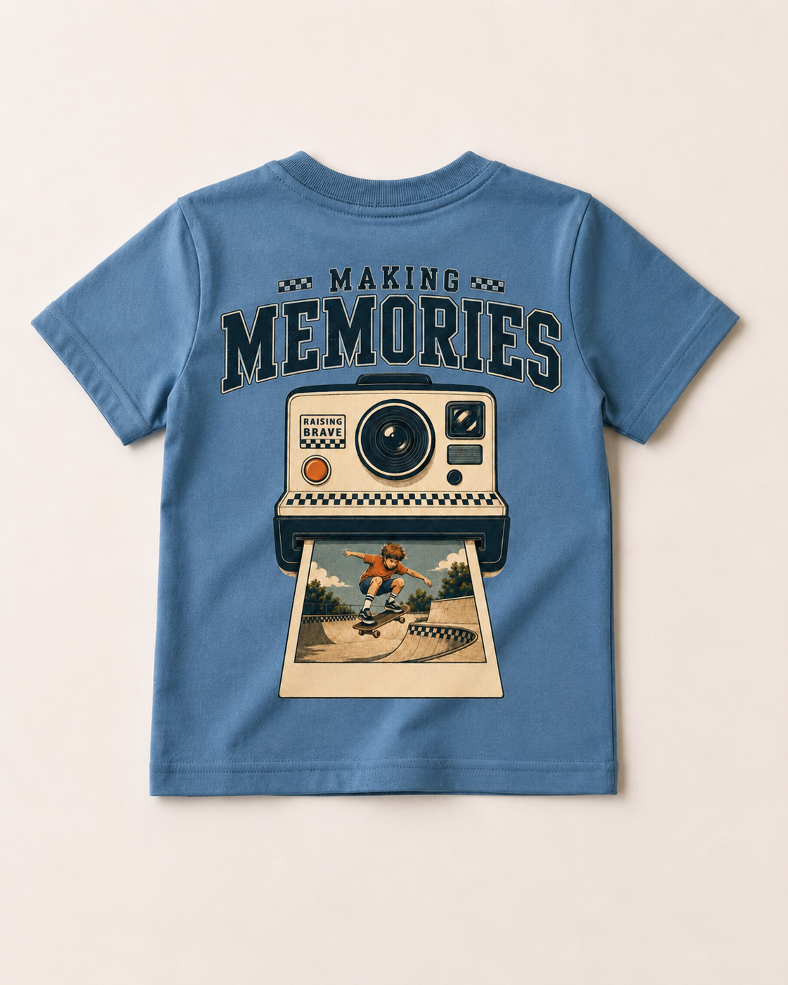 Blue t-shirt with a graphic of a camera and a person on a skateboard, labeled 'Making Memories'.