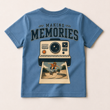 Blue t-shirt with a graphic of a camera and a person on a skateboard, labeled 'Making Memories'.