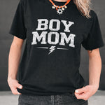Person wearing a black t-shirt with 'BOY MOM' text and a lightning bolt graphic.