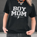 Person wearing a black t-shirt with 'BOY MOM' text and a lightning bolt graphic.