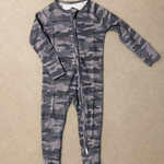 A long-sleeve baby footless one-piece jumpsuit with a gray and black camouflage pattern and a front zipper, laid flat on a textured beige background.