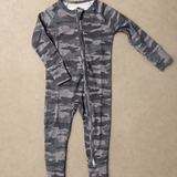 A long-sleeve baby footless one-piece jumpsuit with a gray and black camouflage pattern and a front zipper, laid flat on a textured beige background.