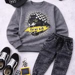 Gray sweatshirt with panther graphic, black jeans, checkered cap, sneakers, and vintage game console on a light gray background.