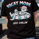 Child wearing a black skeleton vacation tee outside at the park.