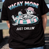 Child wearing a black skeleton vacation tee outside at the park.