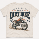 Beige t-shirt with dirt bike graphic and text on a white background