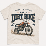 Beige t-shirt with dirt bike graphic and text on a white background