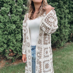 Woman wearing a patterned crochet cardigan outdoors