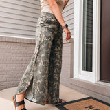 Person wearing camouflage pants standing on a porch with a 'HELLO' doormat.