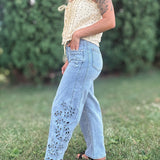 Side view of Women in Embroidered Floral Jeans Outside.