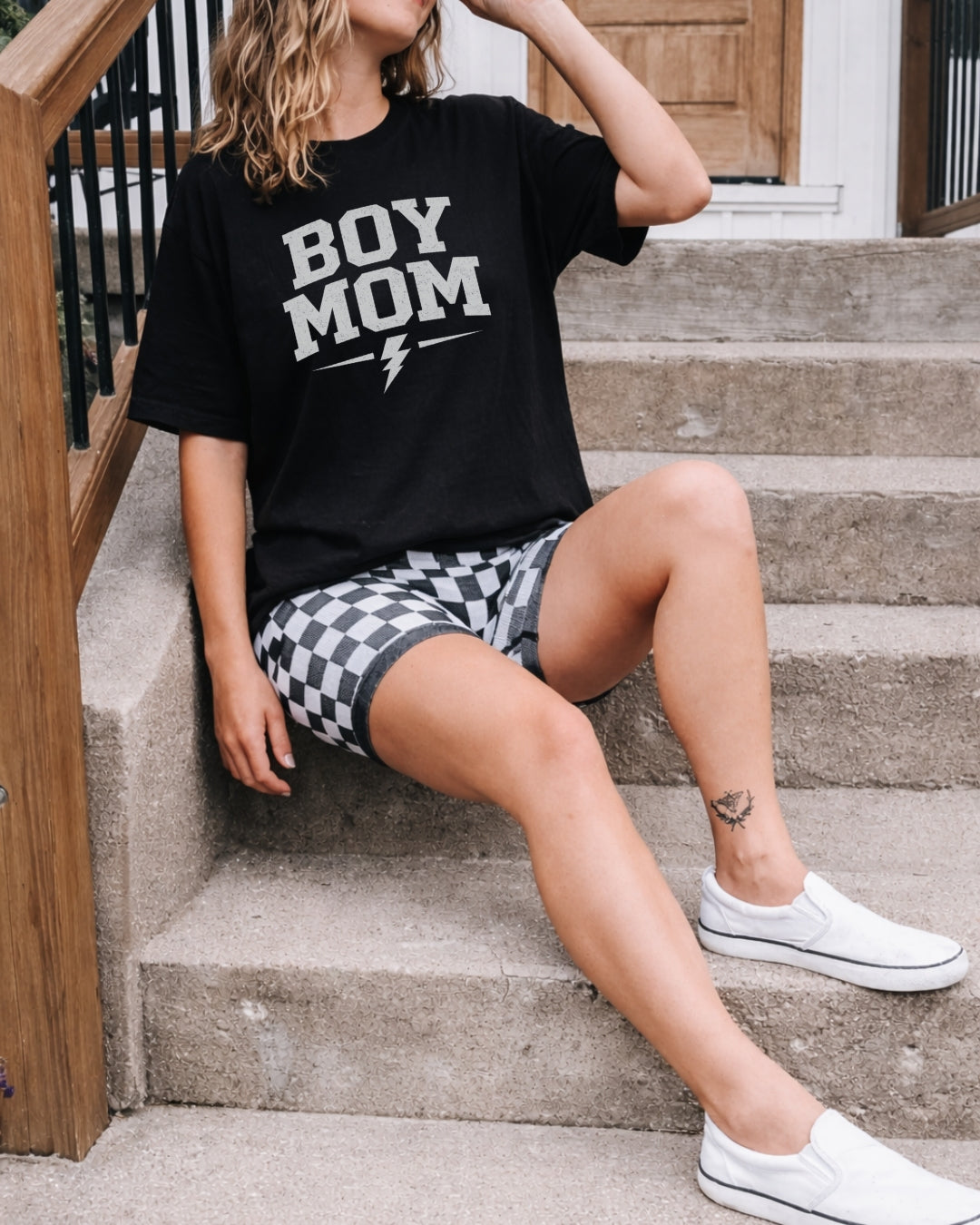 Women sitting on steps wearing Boy Mom tee.