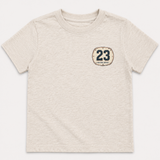 Beige t-shirt with a dirt bike plate with the number 23 on a white background