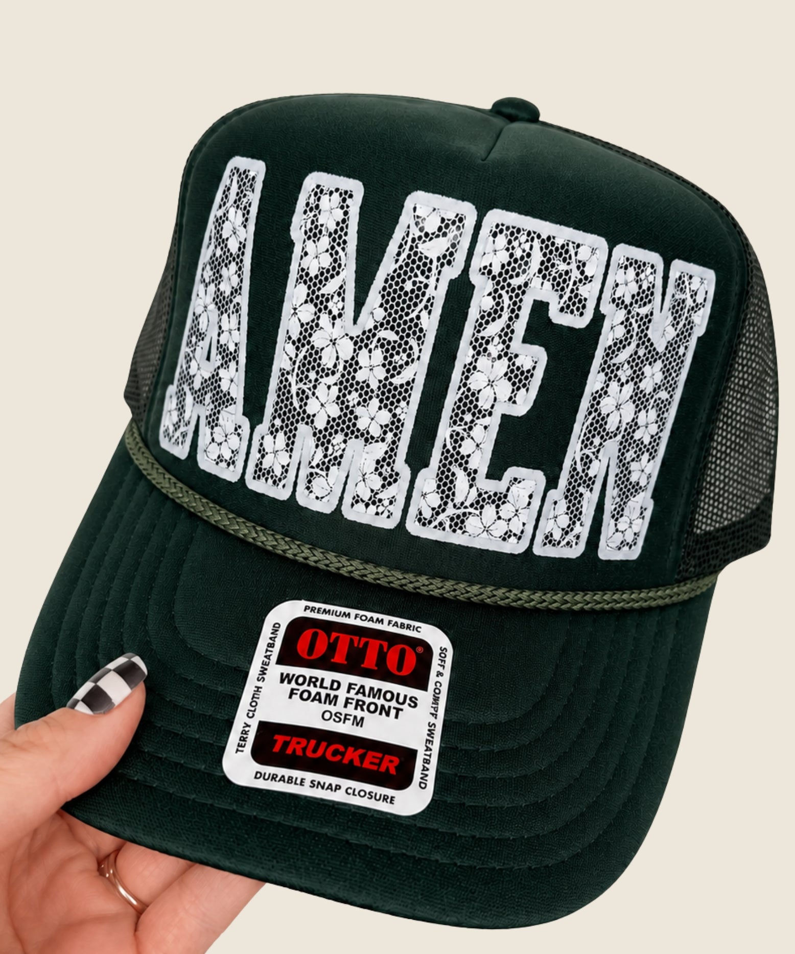 Hand holding Olive Green Amen Trucker Hat.