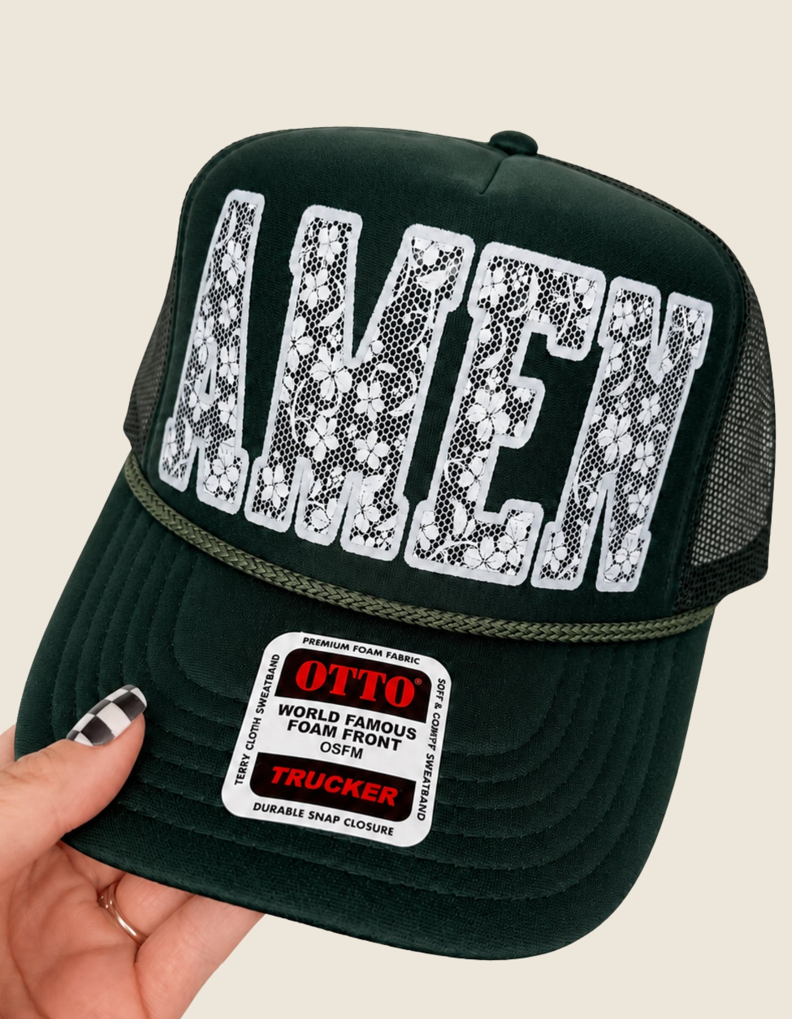 Hand holding Olive Green Amen Trucker Hat.