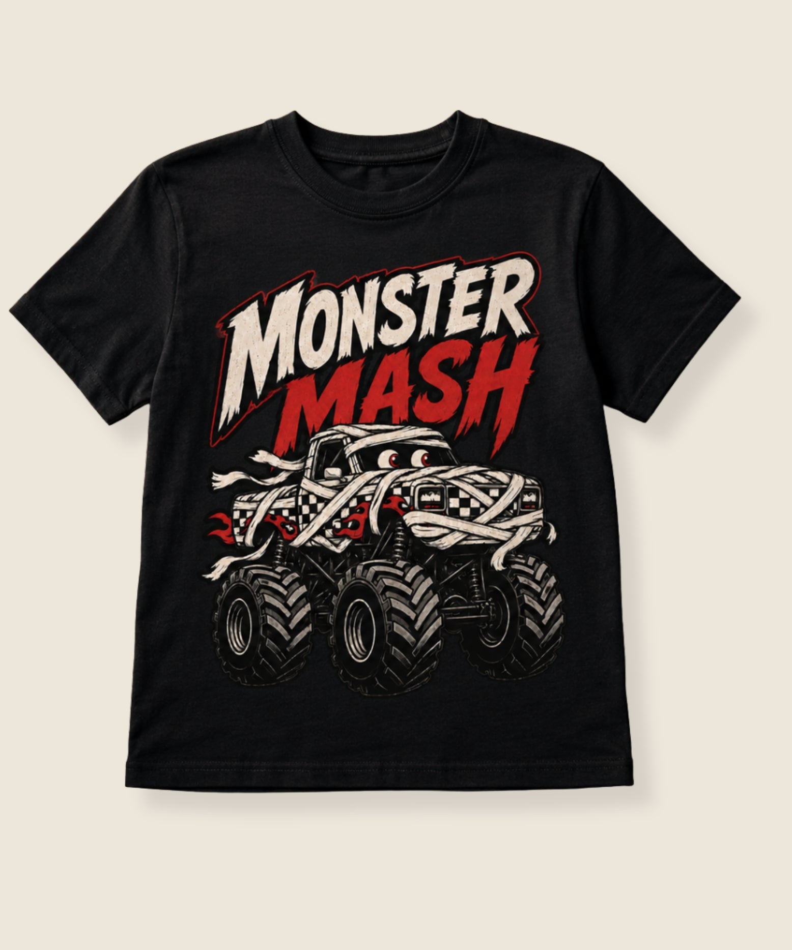 A black short-sleeve t-shirt with a 'Monster Mash' graphic on the front, featuring a stylized monster truck and bold text, displayed against a light beige background.