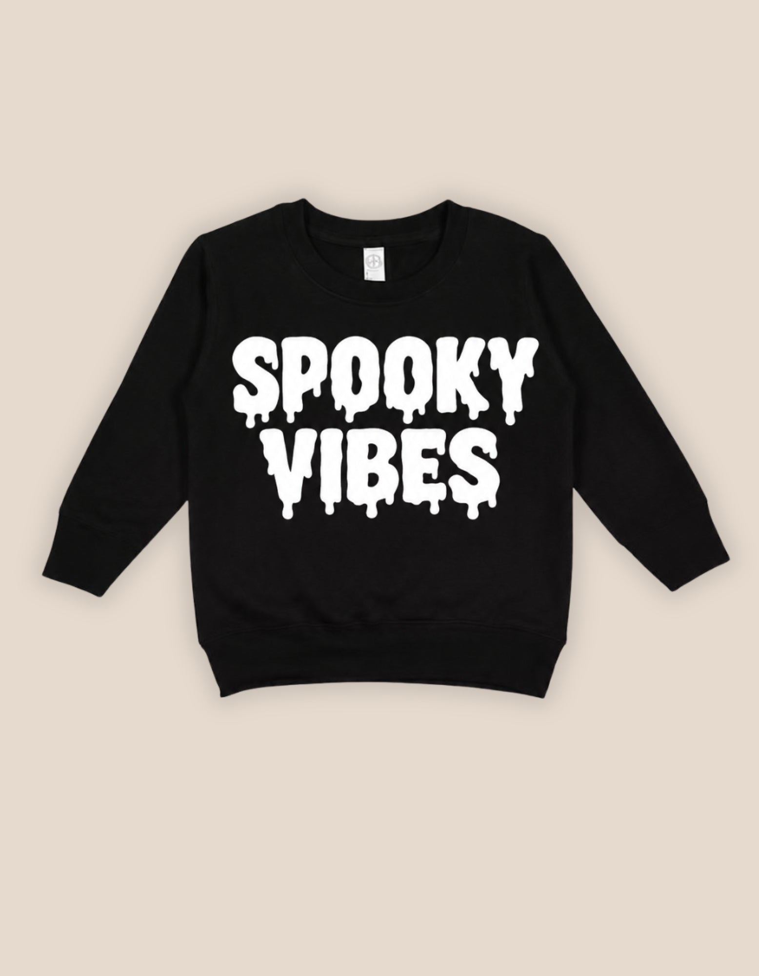 A black long-sleeve sweatshirt with 'SPOOKY VIBES' printed in a white dripping font across the chest, displayed flat against a light beige background.